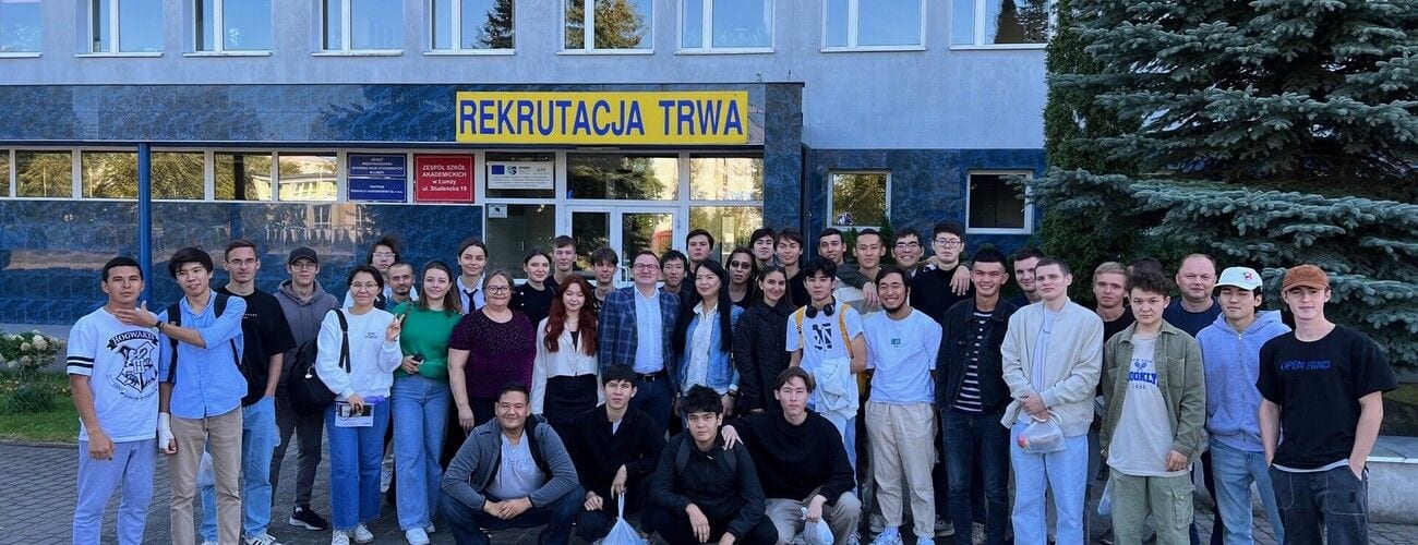 Studenci i gospodarze wizyty z Kazachstanu przed wejściem do uczelni.